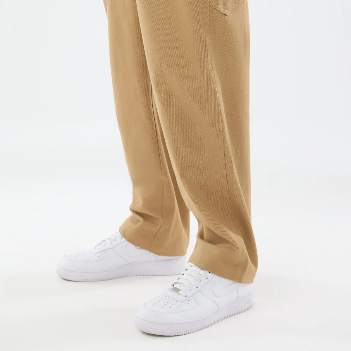 The model is wearing these New Era Work Pants in beige. 7