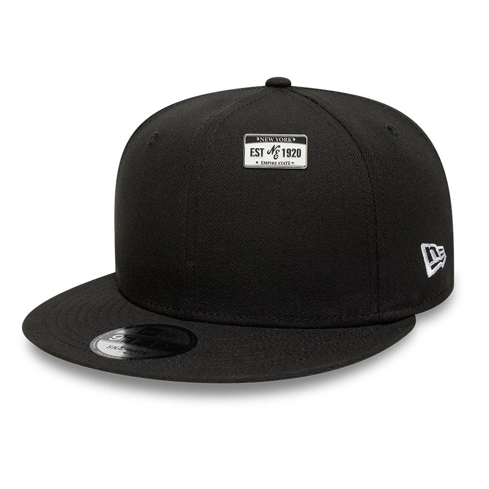 Pictured is this New Era License Plate Pinbadge in silver. 2