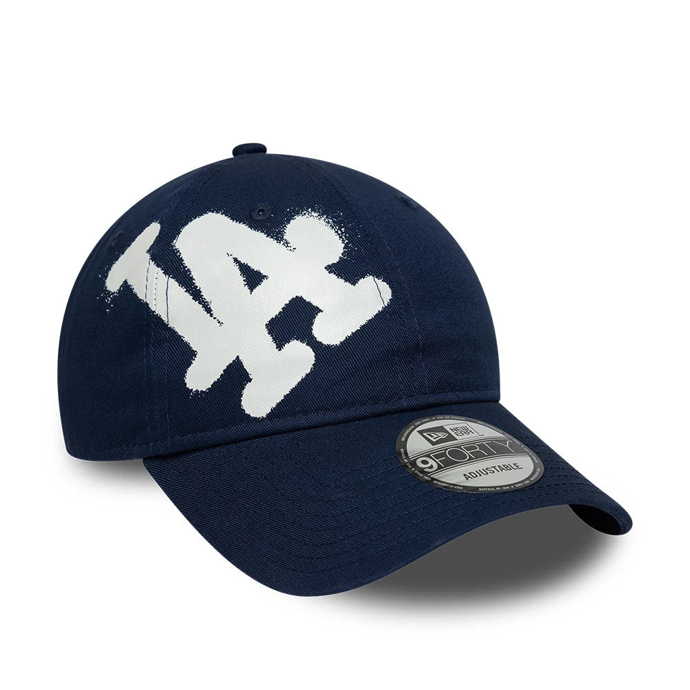 LA Dodgers MLB Spray Paint Dark Blue New Era 9FORTY Adjustable Cap, front view showing the white spray paint-style LA logo embroidered on the front panel, with a curved visor featuring the 9FORTY size sticker.