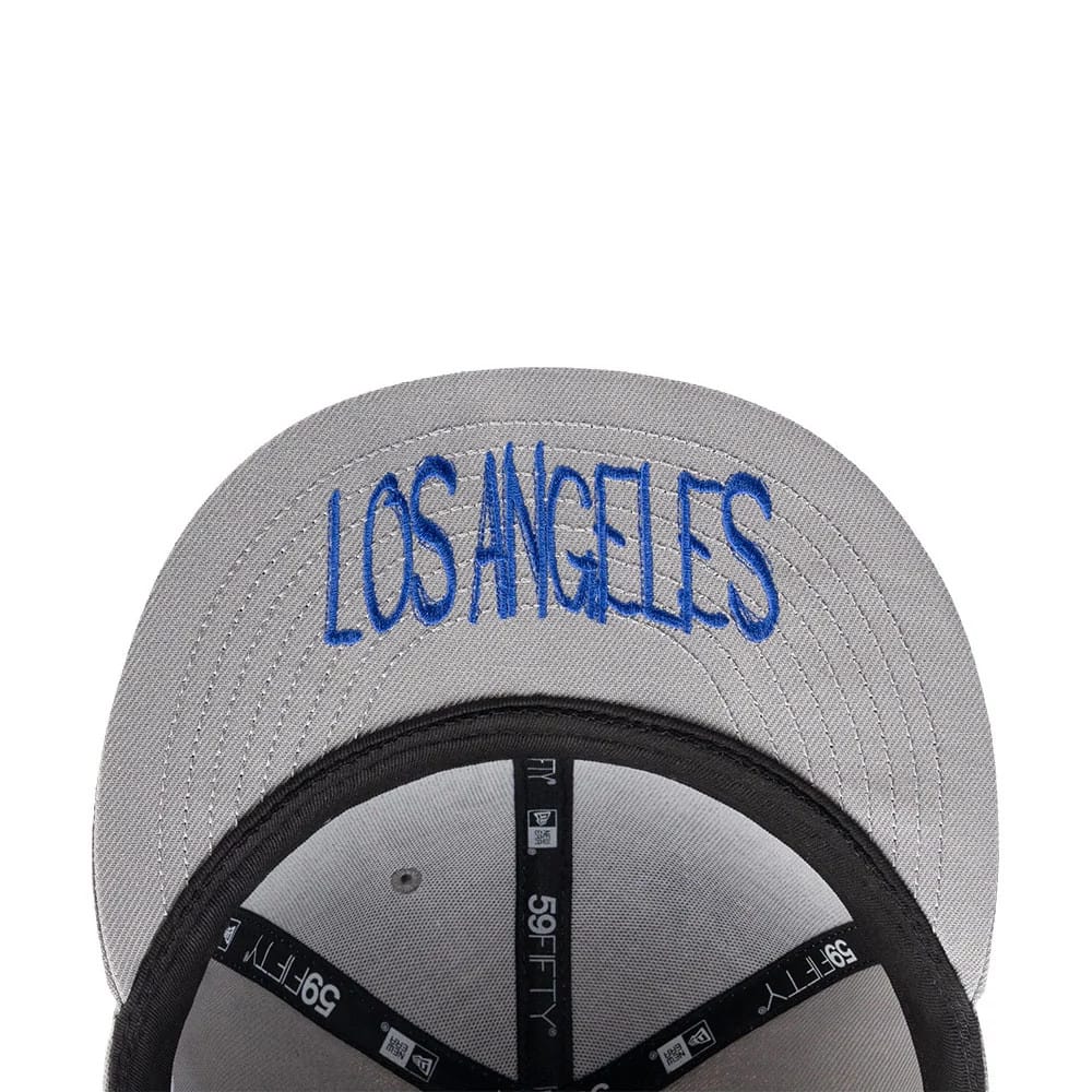 Los Angeles Dodgers MLB Punkcore Grey New Era 59FIFTY Fitted Cap, inside view showing black taping with white 59FIFTY branding, a blue LOS ANGELES embroidery on the grey underside of the visor, and the black sweatband.