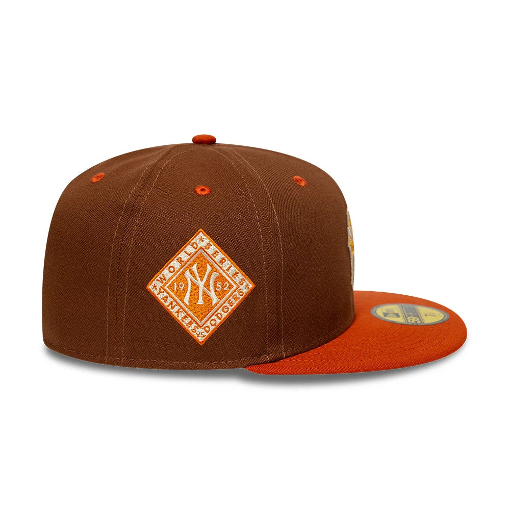 New York Yankees MLB Pack Brown New Era 59FIFTY Fitted Cap, side view showing an orange embroidered diamond-shaped 1952 World Series patch on the side panel and an orange visor with a gold 59FIFTY size sticker.