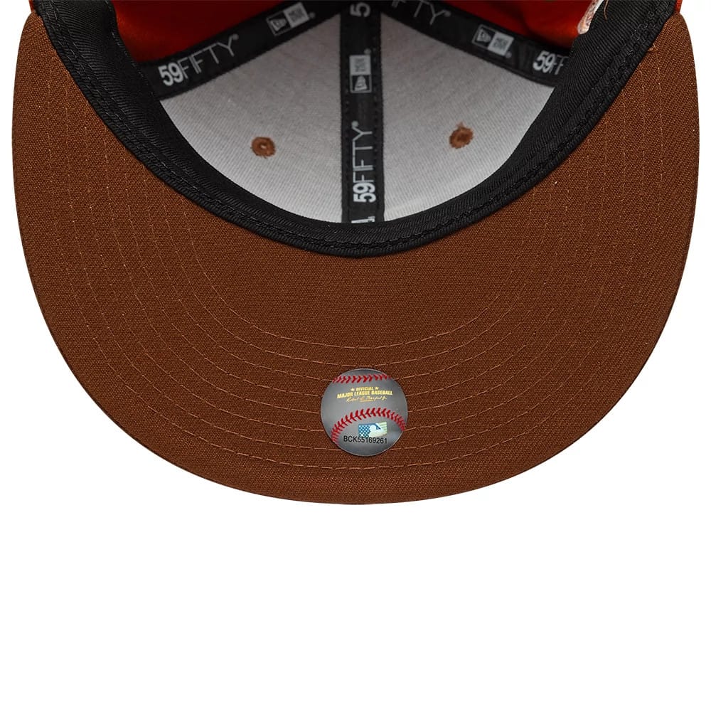 Los Angeles Dodgers MLB Pack Dark Orange New Era 59FIFTY Fitted Cap, inside view showing black 59FIFTY taping and a grey sweatband beneath the dark orange undervisor, with a baseball hologram sticker on the underside of the visor.