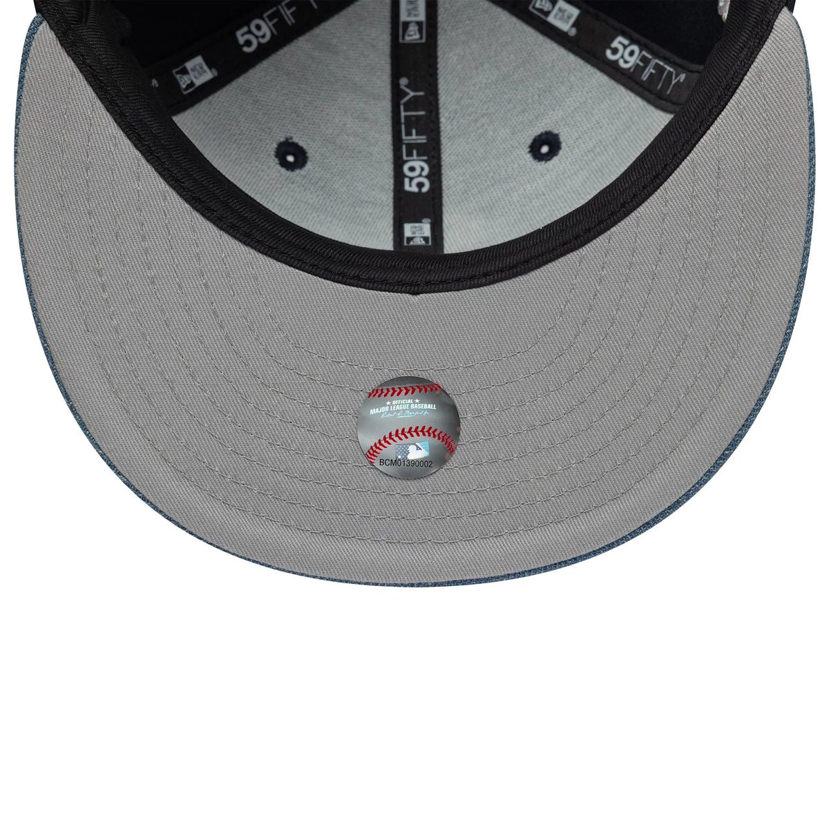 Chicago White Sox MLB Denim Mix Navy New Era 59FIFTY Fitted Cap, inside view showing black branded taping and a grey undervisor with a MLB holographic sticker, set against dark crown lining and contrasting stitching.