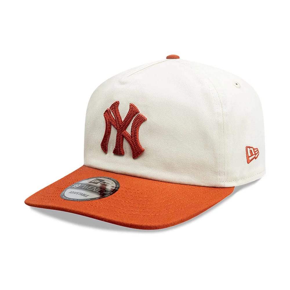 New York Yankees MLB Pack Cream & Orange New Era 19TWENTY Adjustable Cap, three-quarter view showing the orange embroidered NY logo on the front panels, an orange visor with a 19TWENTY size sticker, and the New Era flag logo on the left side.