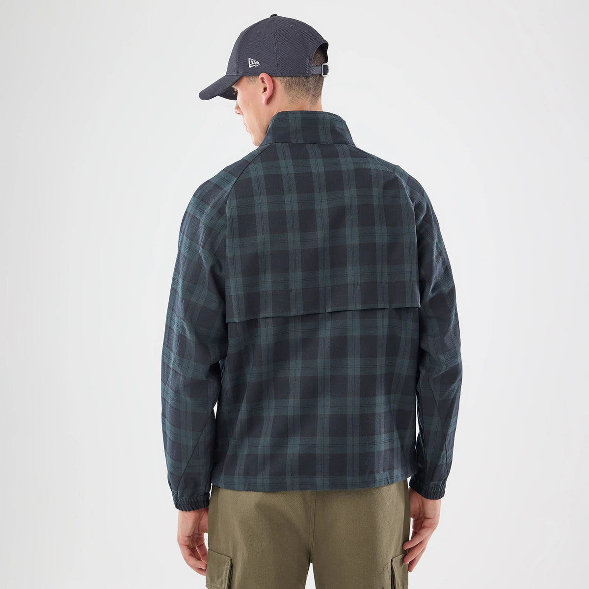 The model is wearing this New Era Blouson Plaid Windbreaker Jacket in Navy. 2