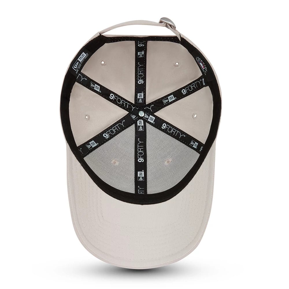 New York Yankees Tonal Stone New Era 9FORTY Cap, inside view showing black branded taping across the tan crown interior, white sewn eyelets, and no inside sticker on the grey undervisor.