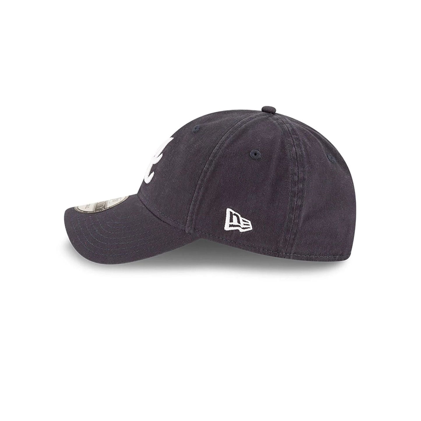 Atlanta Braves MLB Core Classic Navy New Era 9TWENTY Adjustable Cap, side view showing the raised white A logo on the front panel, white New Era flag logo on the left side, and the curved visor with a 9TWENTY size sticker.