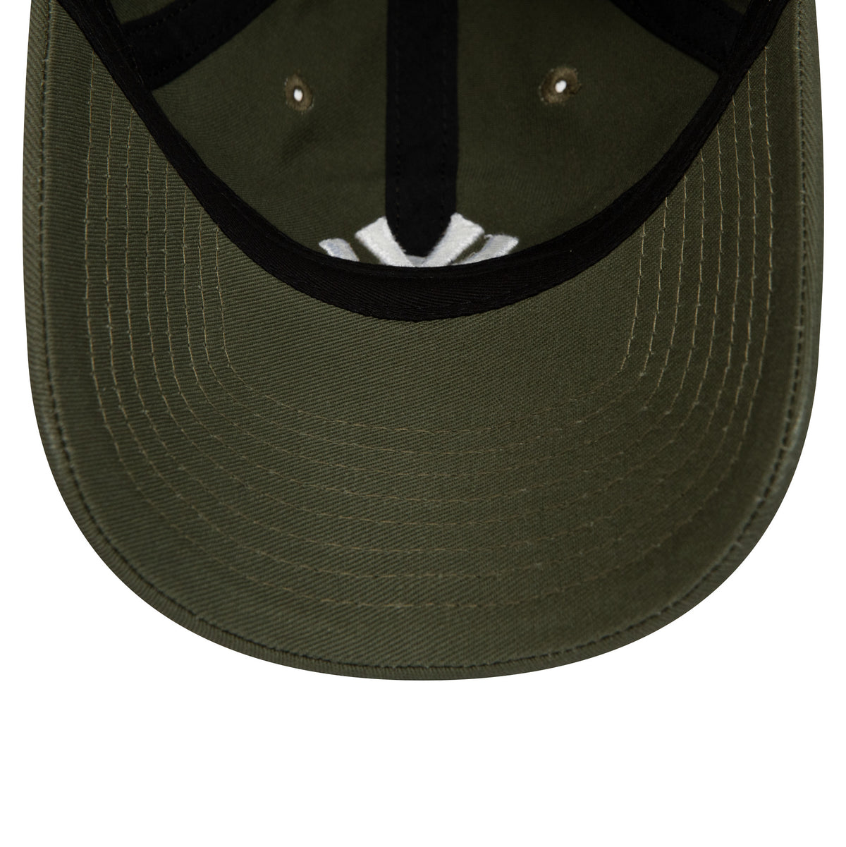 New York Yankees League Essential Green New Era 9TWENTY Adjustable Cap, inside view showing the white taping on the green undervisor and black sweatband, with the cap's inner stitching and eyelet details.