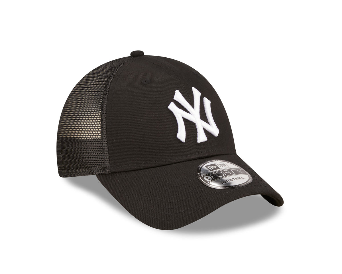 New York Yankees Home Field Black New Era 9FORTY A-Frame Trucker Cap, three-quarter view showing the white raised NY logo on the front panel, black mesh back panels, and the 9FORTY size sticker on the black curved visor.