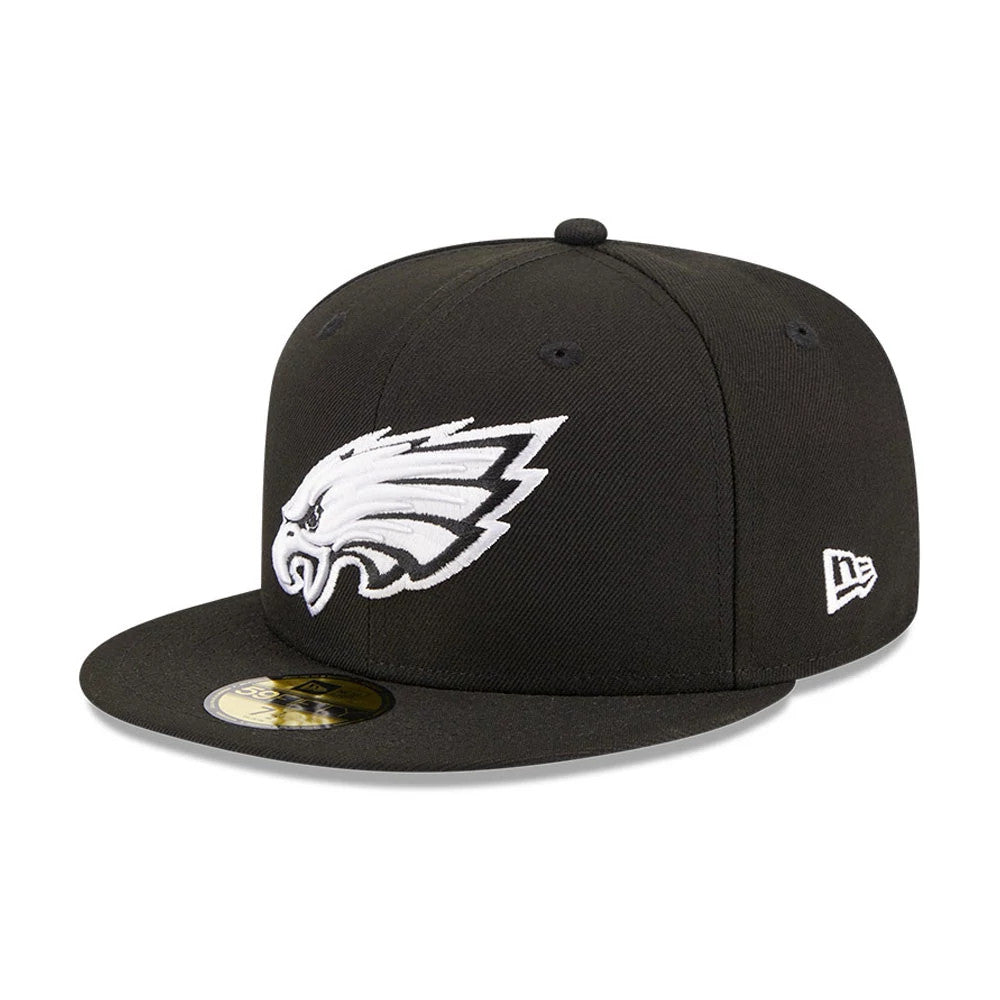 Philadelphia Eagles NFL Evergreen Black New Era 59FIFTY Fitted Cap, three-quarter view with a raised white embroidered eagle logo on the front panel, black visor with gold 59FIFTY size sticker, and New Era flag logo on the left side.