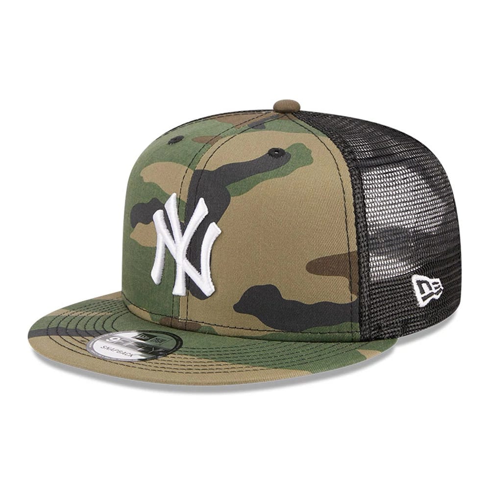 New York Yankees MLB Evergreen Camo New Era 9FIFTY Trucker Adjustable Cap, three-quarter view showing the white raised embroidered NY logo on the front panel, black mesh rear panels, and 9FIFTY size sticker on the camo-patterned visor.