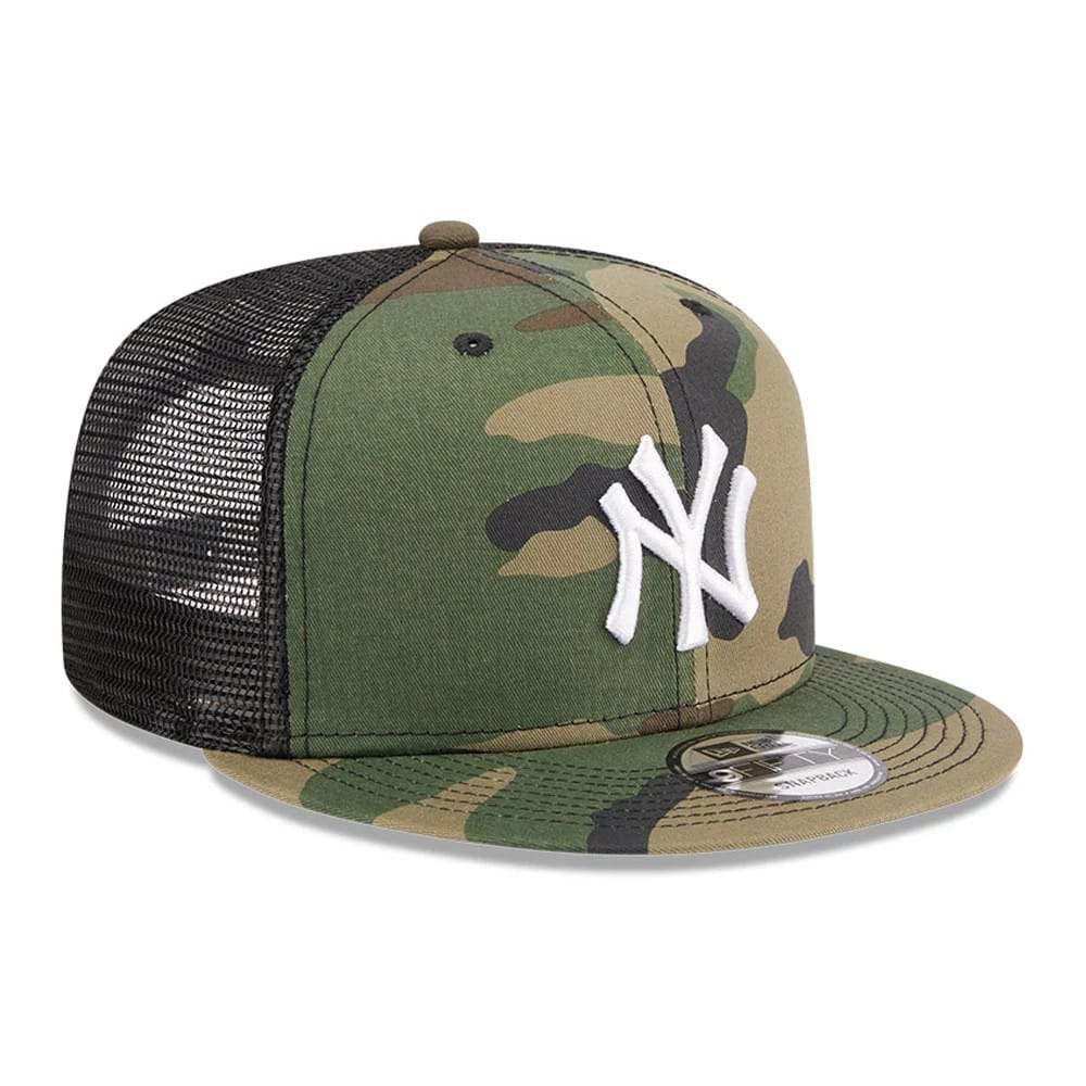 New York Yankees MLB Evergreen Camo New Era 9FIFTY Trucker Adjustable Cap, three-quarter view showing a white embroidered NY logo on the front panel, with a camouflage visor and a 9FIFTY size sticker on the visor.