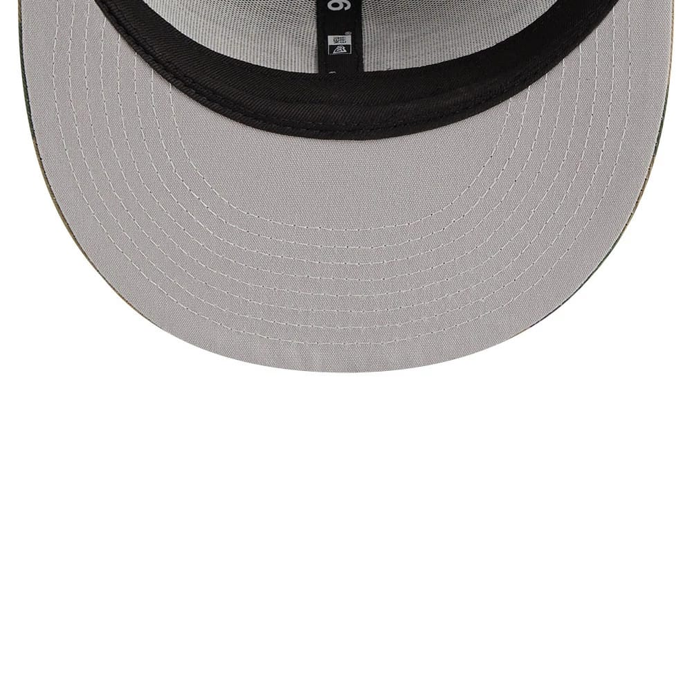 New York Yankees MLB Evergreen Camo New Era 9FIFTY Trucker Adjustable Cap, inside view showing the black taping with white stitching and the grey undervisor, creating a contrast with the structured crown.