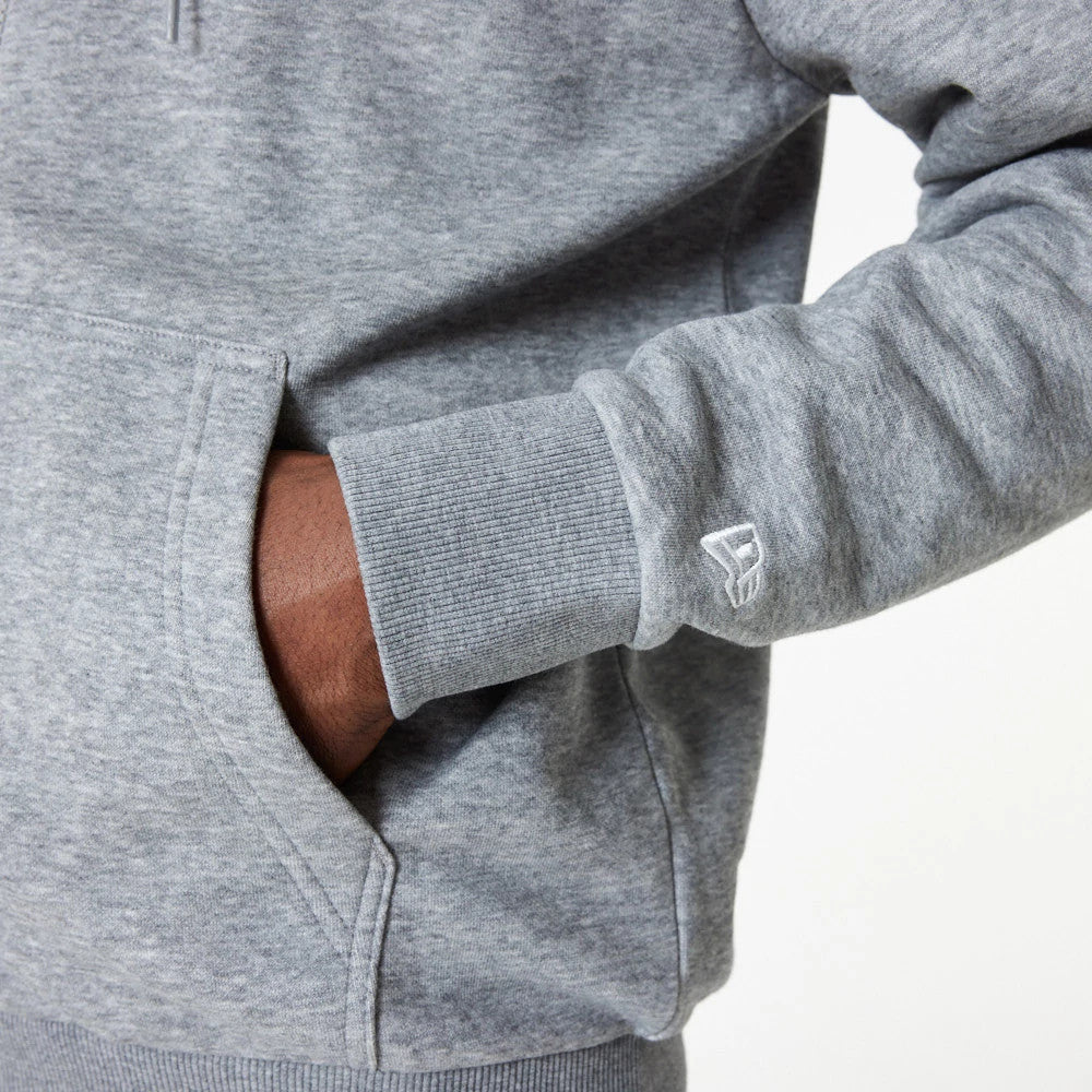 New York Yankees MLB Essential Grey Full Zip Hoodie, side view showing a grey sleeve with ribbed cuffs, a hand resting in the front pocket and an embroidered white New Era logo near the cuff.