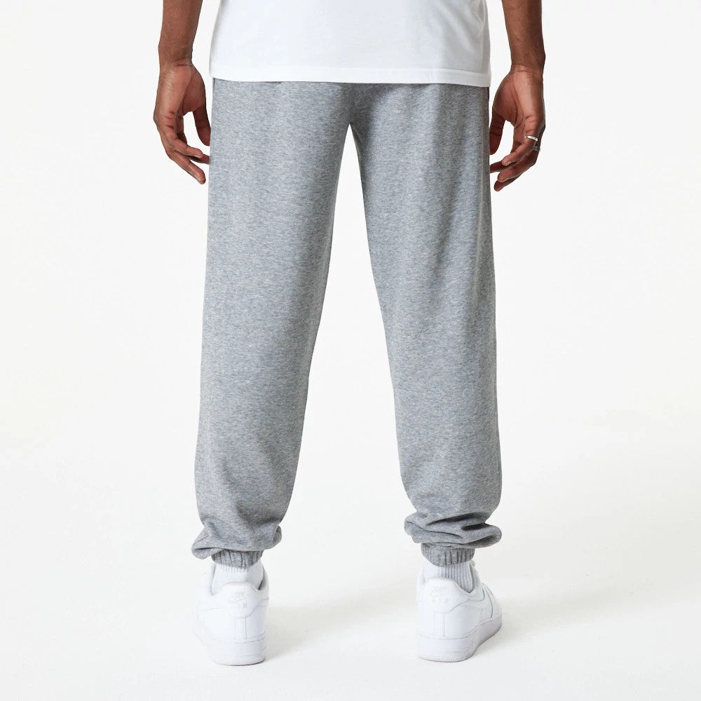 New Era New York Yankees MLB Essential Grey Joggers, rear view on a model showing elasticated cuffs and a relaxed fit, paired with white trainers and a white shirt for a casual look.