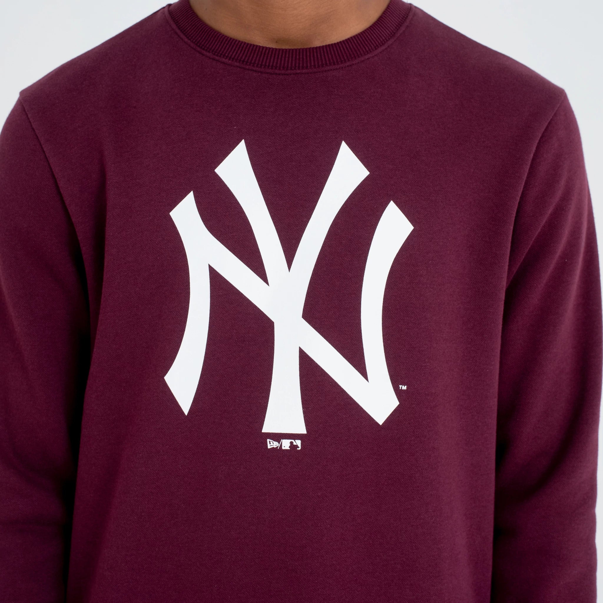 New York Yankees MLB Regular Dark Purple Crew Neck Sweatshirt, front view on a model showing the bold white NY logo centred on the chest, with ribbed neckline and rich dark purple colour.