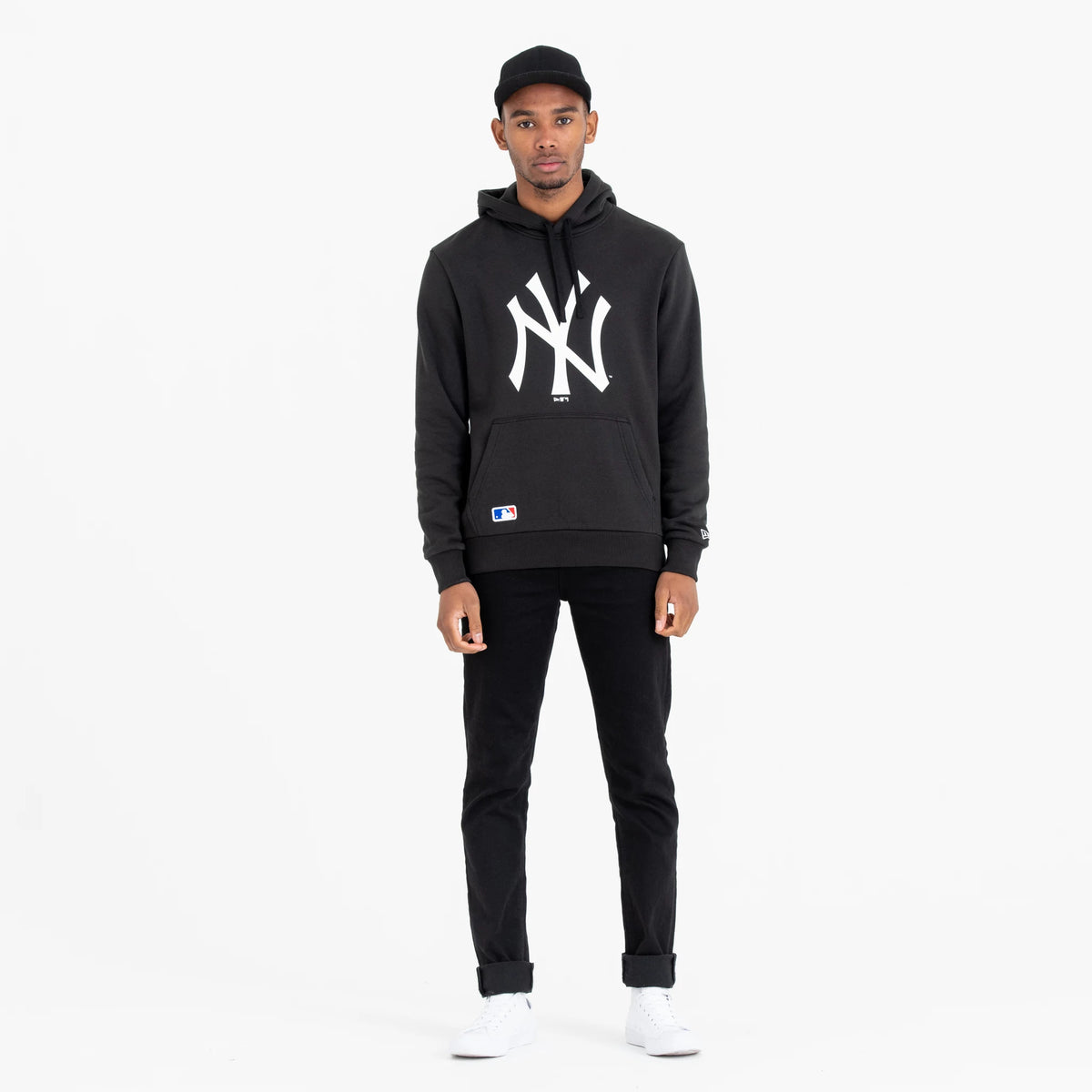 New York Yankees MLB Regular Black Pullover Hoodie, on-model view showing a large white NY logo on the chest, a kangaroo pocket at the front, and the MLB Batterman logo near the hem.