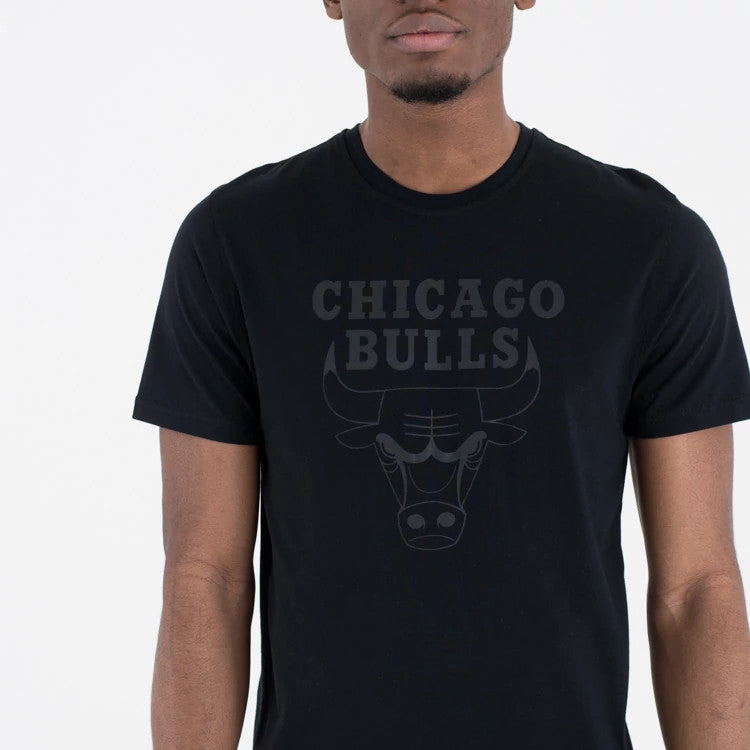 New Era Chicago Bulls NBA Regular Black On Black T-Shirt, front view showing the black crew neck design with a raised Chicago Bulls logo and team name embossed on the chest, worn by a model.