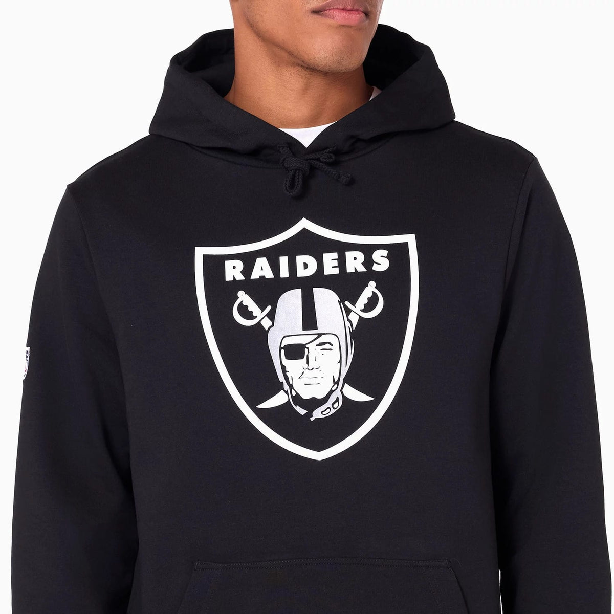 Las Vegas Raiders NFL Black Pullover Hoodie, front view showing the bold white Raiders logo emblazoned on the centre of the chest, with a black hood featuring drawstrings and part of a kangaroo pocket visible at the bottom.