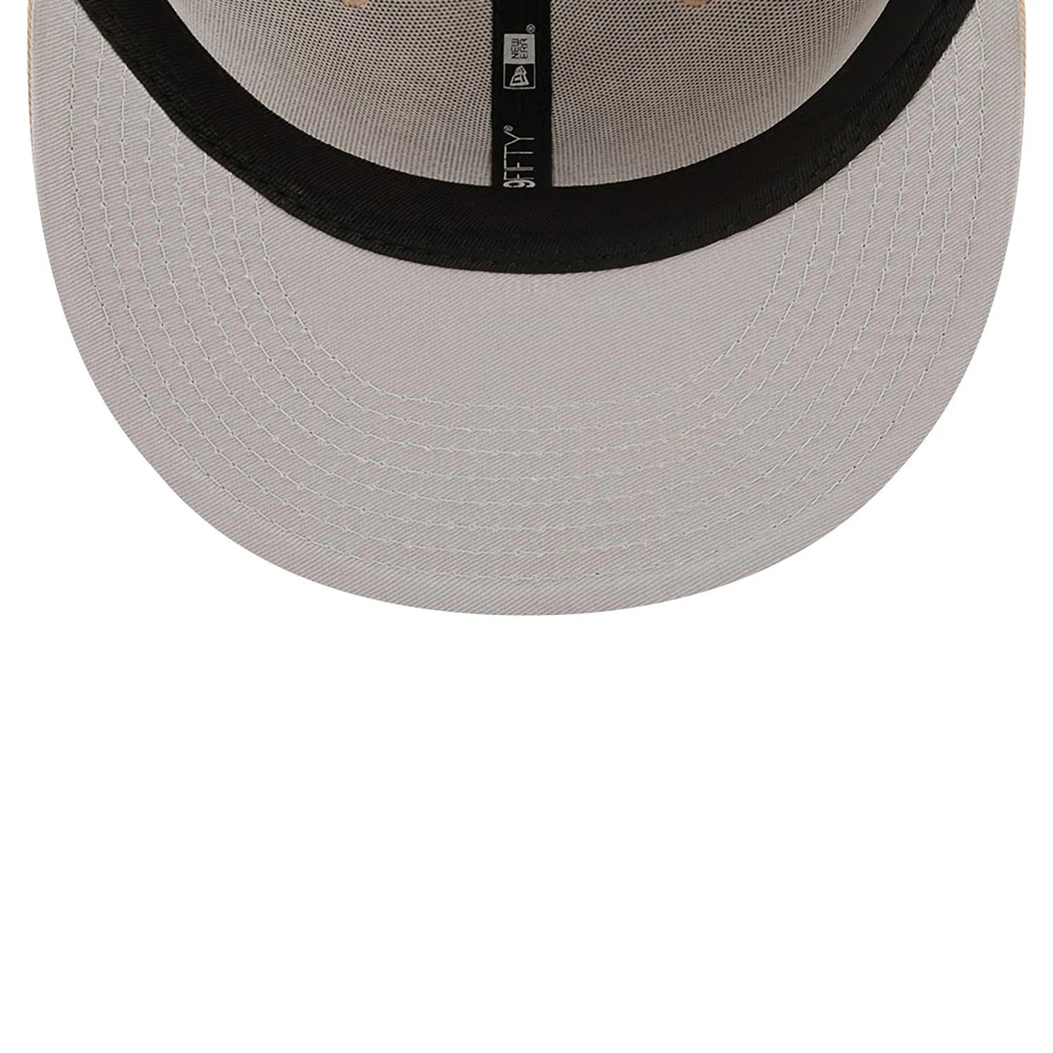 New York Yankees League Essential Stone New Era 59FIFTY Fitted Cap, inside view showing the grey undervisor with black taping featuring the 59FIFTY branding in white, set against a structured design.