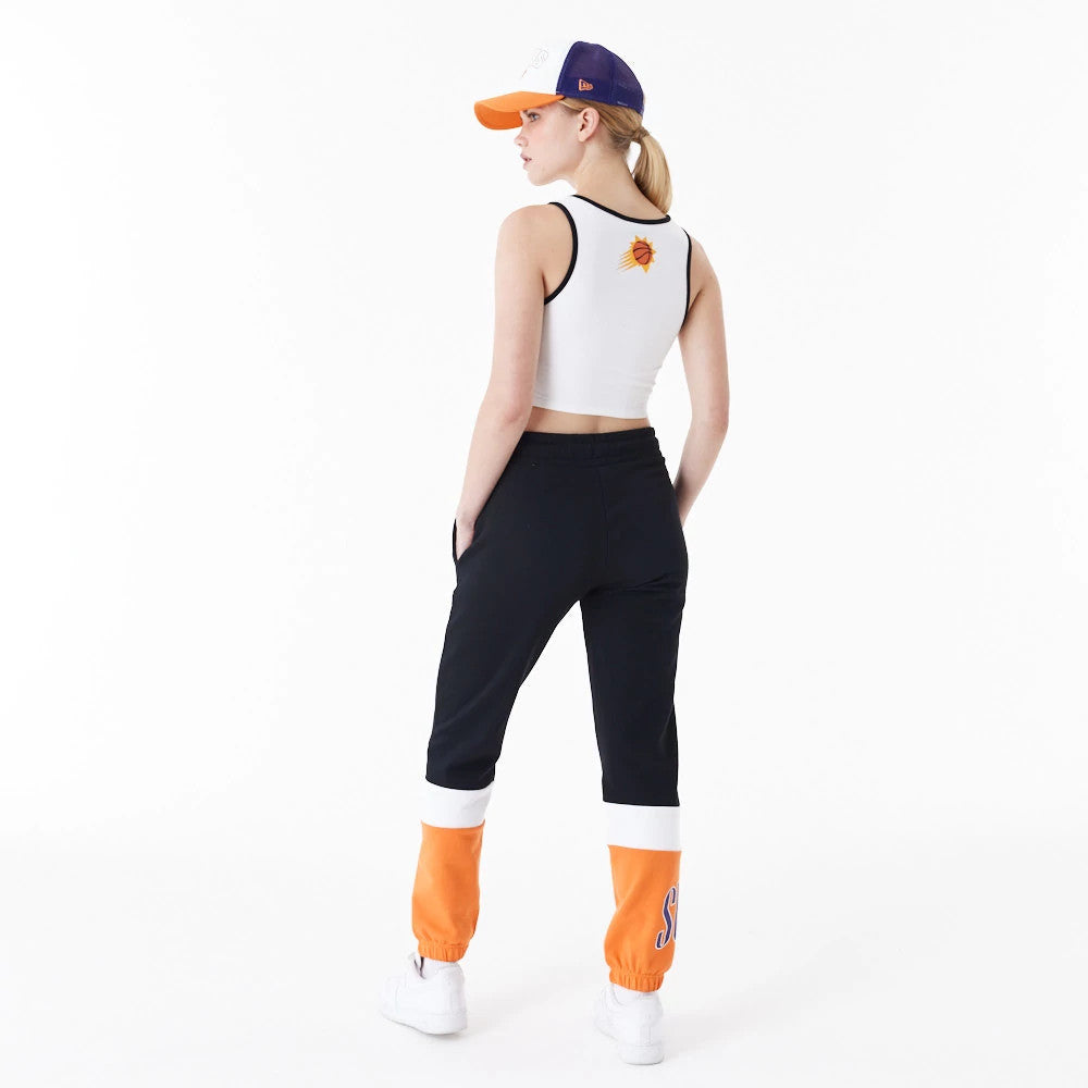 Phoenix Suns Womens NBA Team Wordmark White Crop Tank Top, back view on a model wearing matching black and orange joggers, showing the Phoenix Suns logo centred on the upper back of the sleeveless design.