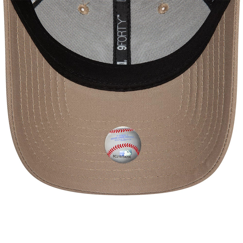 New York Yankees League Essential Pastel Brown New Era 9FORTY Adjustable Cap, inside view showing black sweatband, grey taping with 9FORTY branding, and baseball sticker on the brown undervisor.