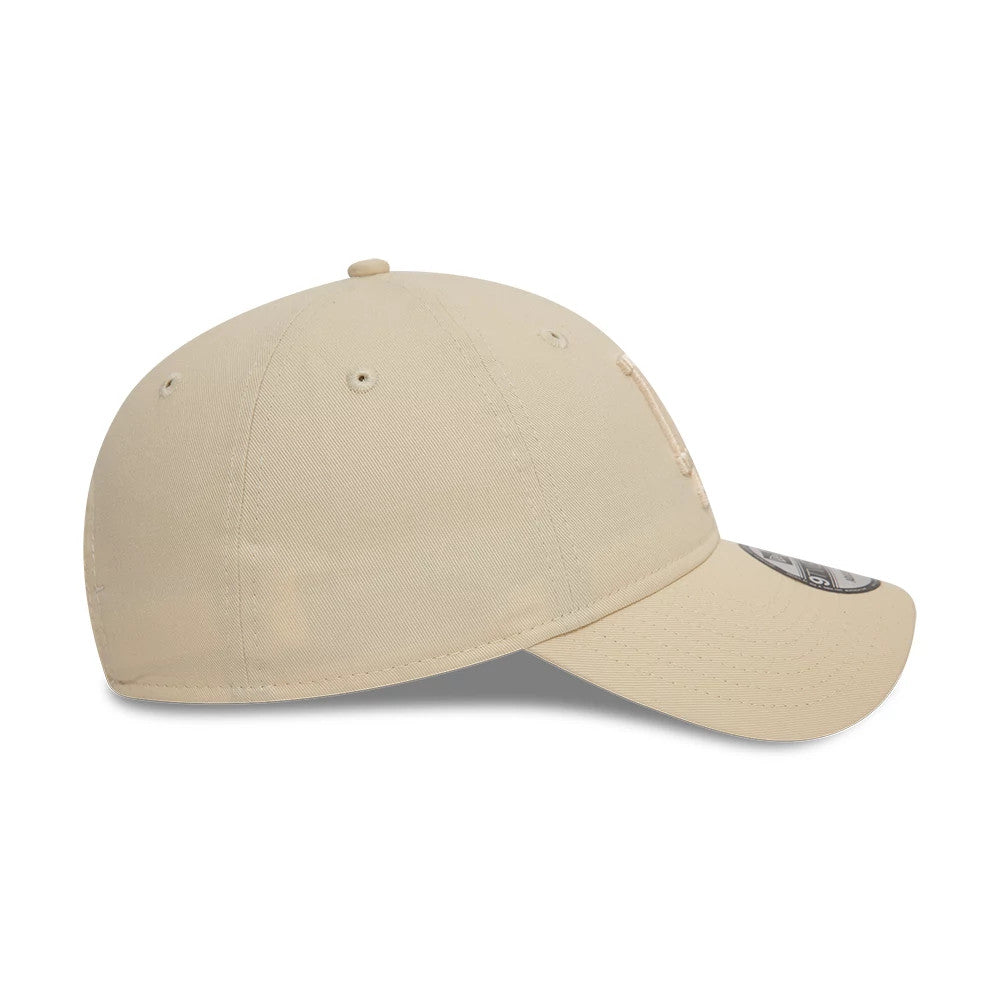 LA Dodgers League Essential Stone New Era 9TWENTY Adjustable Cap, side view showing the embroidered LA logo on the front panel, with an unstructured stone crown and a curved visor featuring the 9TWENTY size sticker.