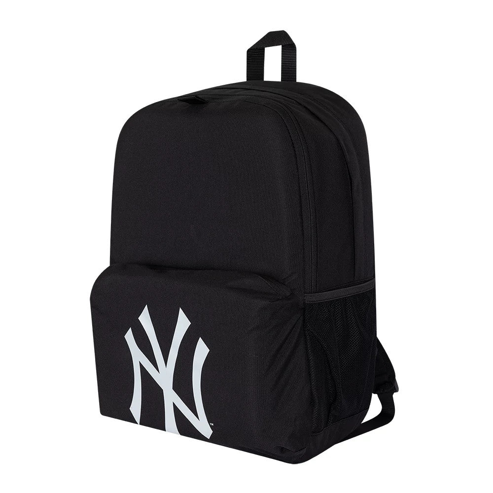 New Era New York Yankees MLB Multi Compartment Black Stadium Backpack, side view showing the spacious black shell with a large white debossed New York Yankees logo on the front pocket, a mesh side pocket, and a loop handle on top.