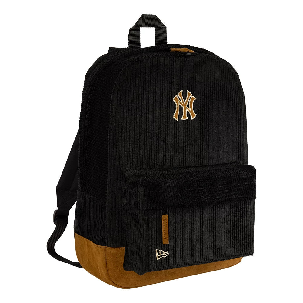 New Era New York Yankees Cord Black Stadium Backpack, front view showing a raised New York Yankees logo centred on the black fabric, with a brown base, a front pocket below the logo, and a debossed New Era logo on the pocket corner.