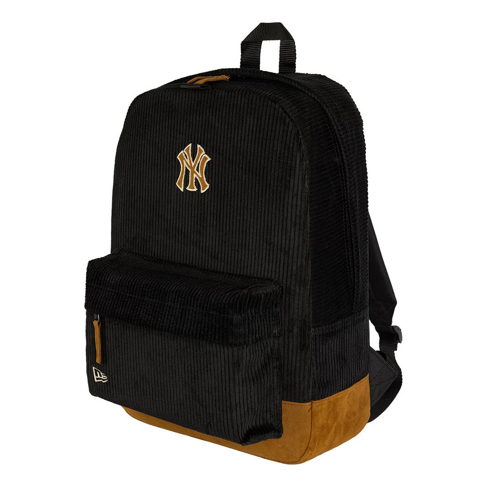 New Era New York Yankees Cord Black Stadium Backpack, three-quarter view showing the black cord fabric with an embroidered Yankees logo on the front pocket, a zip closure and a small raised New Era logo on the lower side.