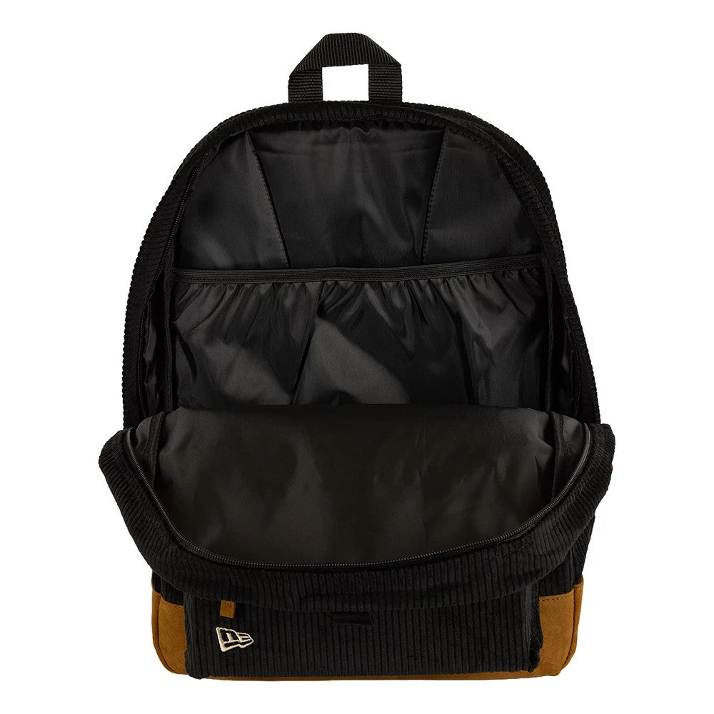 New Era New York Yankees Cord Black Stadium Backpack, open view showing the front flap unzipped to reveal a spacious black interior with an elasticated pocket at the back, and a raised New Era logo on the lower corner of the front flap.