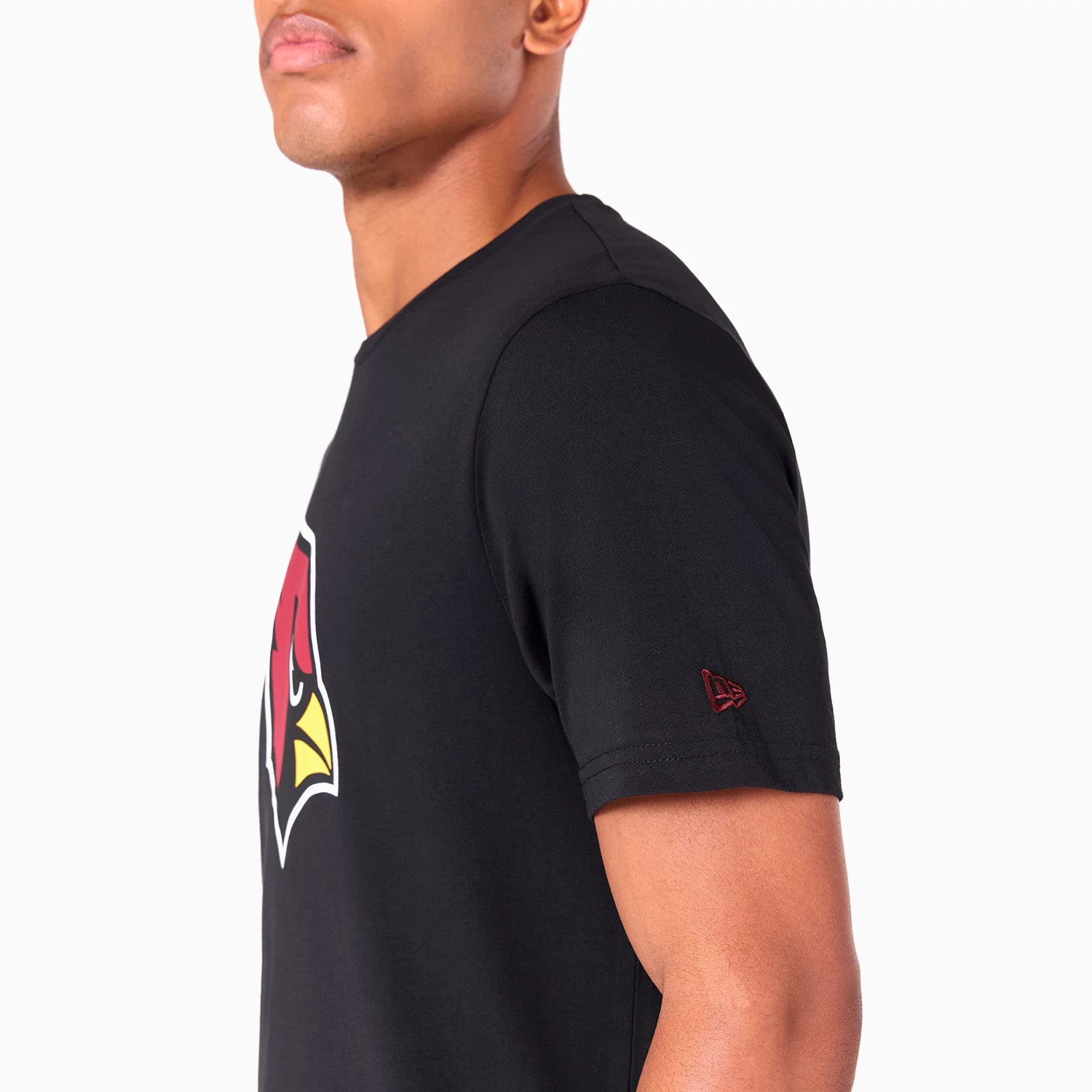 New Era Arizona Cardinals NFL Black T-Shirt, side view showing a large red and yellow Cardinals logo on the chest, with a raised New Era logo embroidered on the sleeve near the edge.