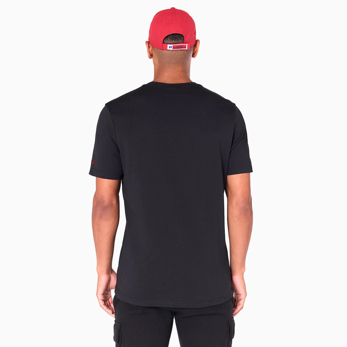 New Era Arizona Cardinals NFL Black T-Shirt, rear view showing the plain black back of the shirt with short sleeves, worn by a model wearing a red cap with an embroidered logo above the opening at the back.