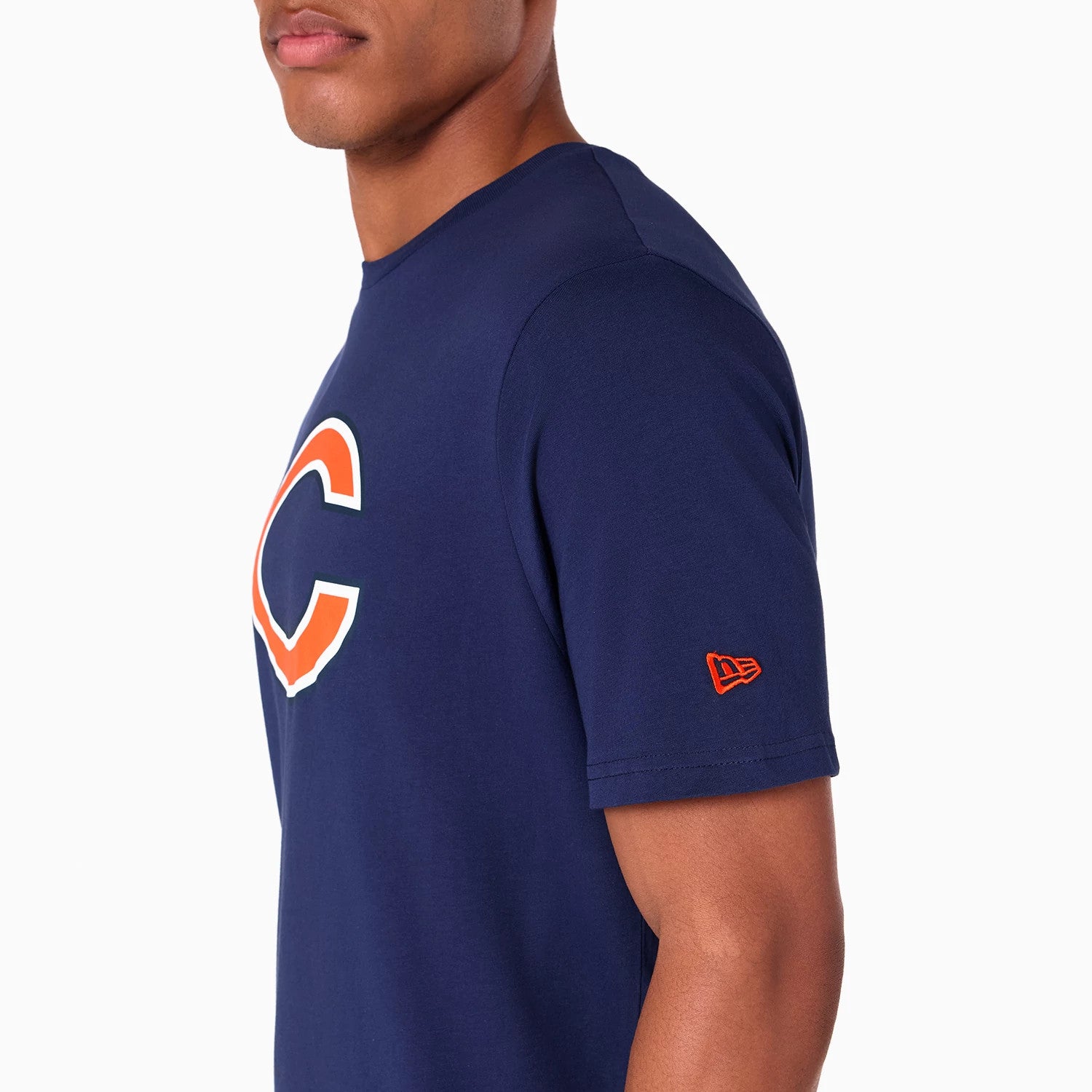 New Era Chicago Bears NFL Navy T-Shirt, side view showing the large orange and white C logo on the chest, short sleeves with a raised orange New Era logo near the sleeve hem, set against a plain navy background.