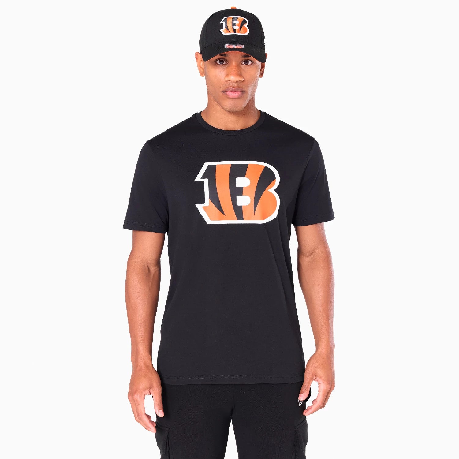 New Era Cincinnati Bengals NFL Black T-Shirt, on-model view showing the large orange and white Bengals logo centred on the chest of the plain black t-shirt, paired with a matching black cap featuring the same logo embossed on the front.
