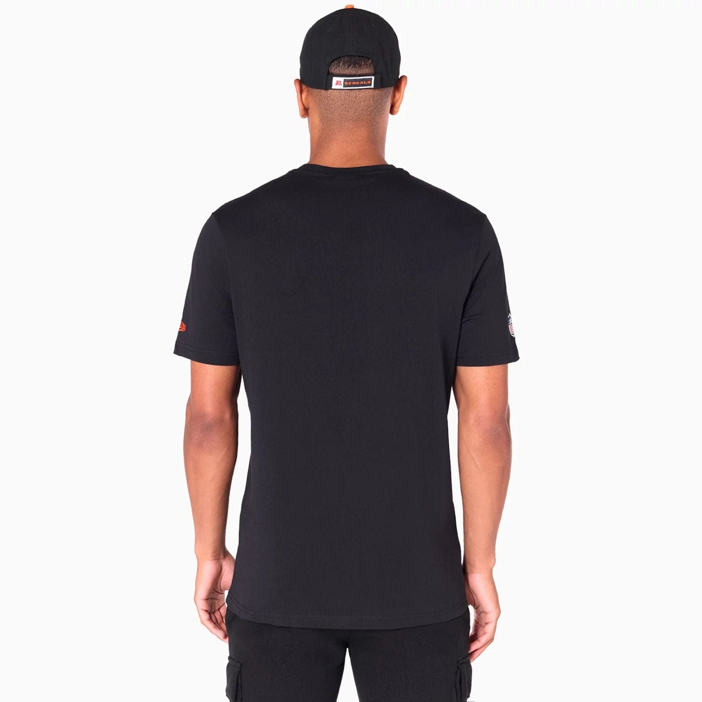 New Era Cincinnati Bengals NFL Black T-Shirt, on-model rear view showing a plain black T-shirt with a debossed New Era logo on the left sleeve and a small team logo patch on a black cap worn by the model.