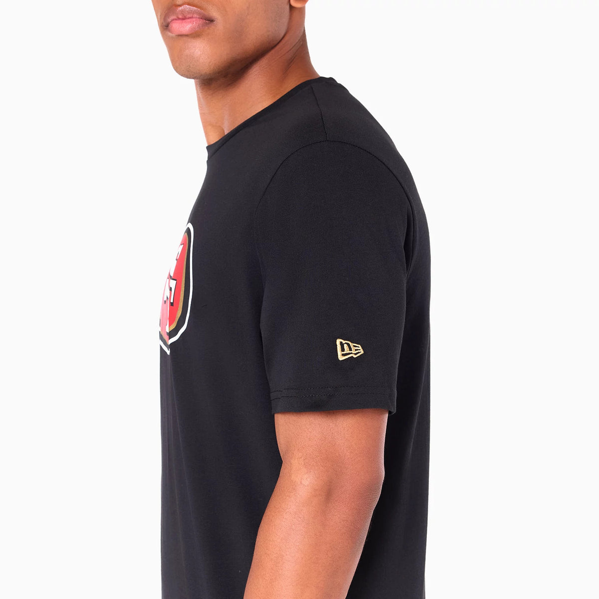 New Era San Francisco 49ers NFL Black T-Shirt, side view showing a black short-sleeve with a raised gold New Era logo on the left sleeve and part of a red and white logo on the front chest area.