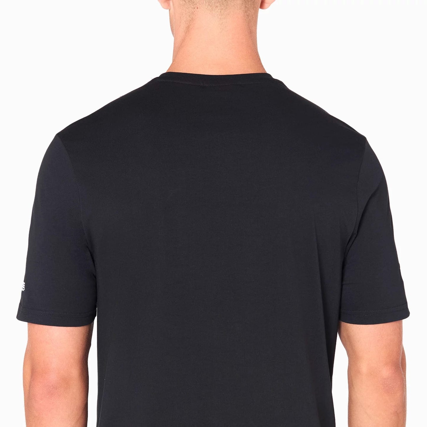 New Era NFL Shield Logo NFL Black T-Shirt, rear view showing the plain black back with short sleeves and a small raised New Era logo on the left sleeve above the hem.