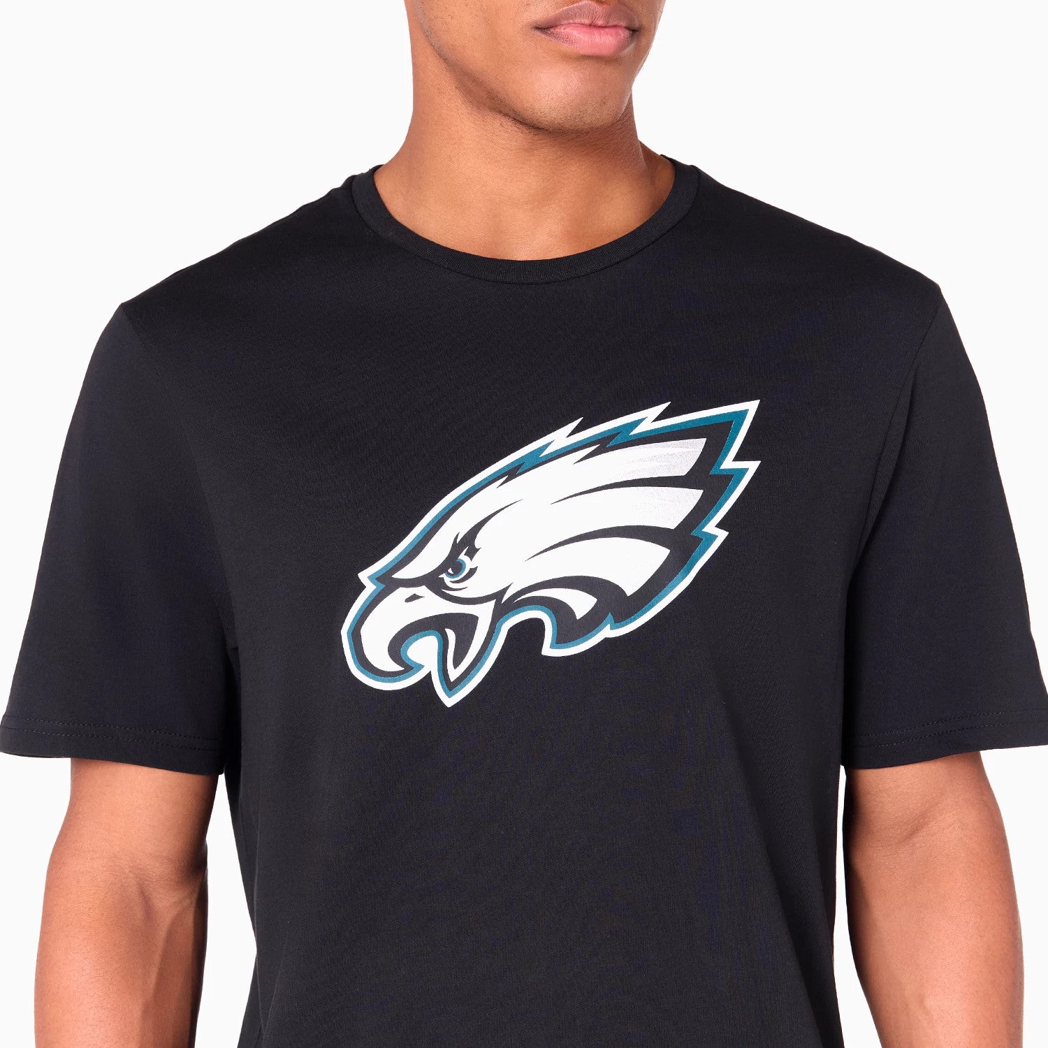 New Era Philadelphia Eagles NFL Black T-Shirt, front view showing the large graphic eagle logo printed in white and teal on the chest, set against a plain black fabric with a crew neck.