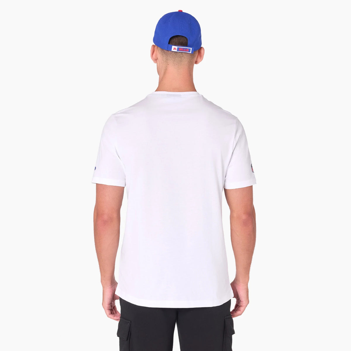 New Era Buffalo Bills NFL White T-Shirt, on-model rear view showing the plain white back of the T-shirt, with the model wearing a blue cap featuring a raised Buffalo Bills logo on the back panel above the adjustment strap.