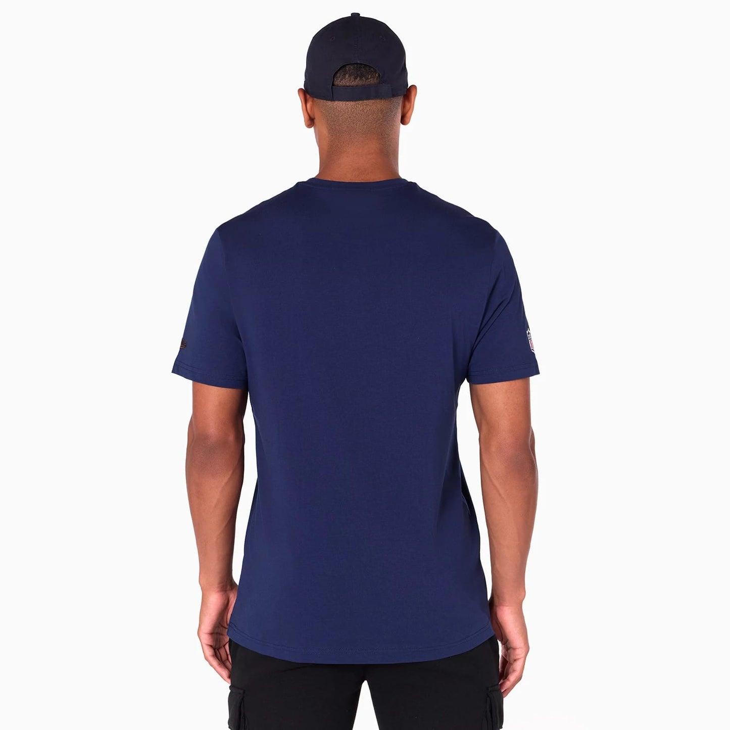 New Era Denver Broncos NFL Navy T-Shirt, rear view showing the solid navy colour with short sleeves, a small embroidered logo on the edge of the right sleeve, worn by a model with a navy cap.
