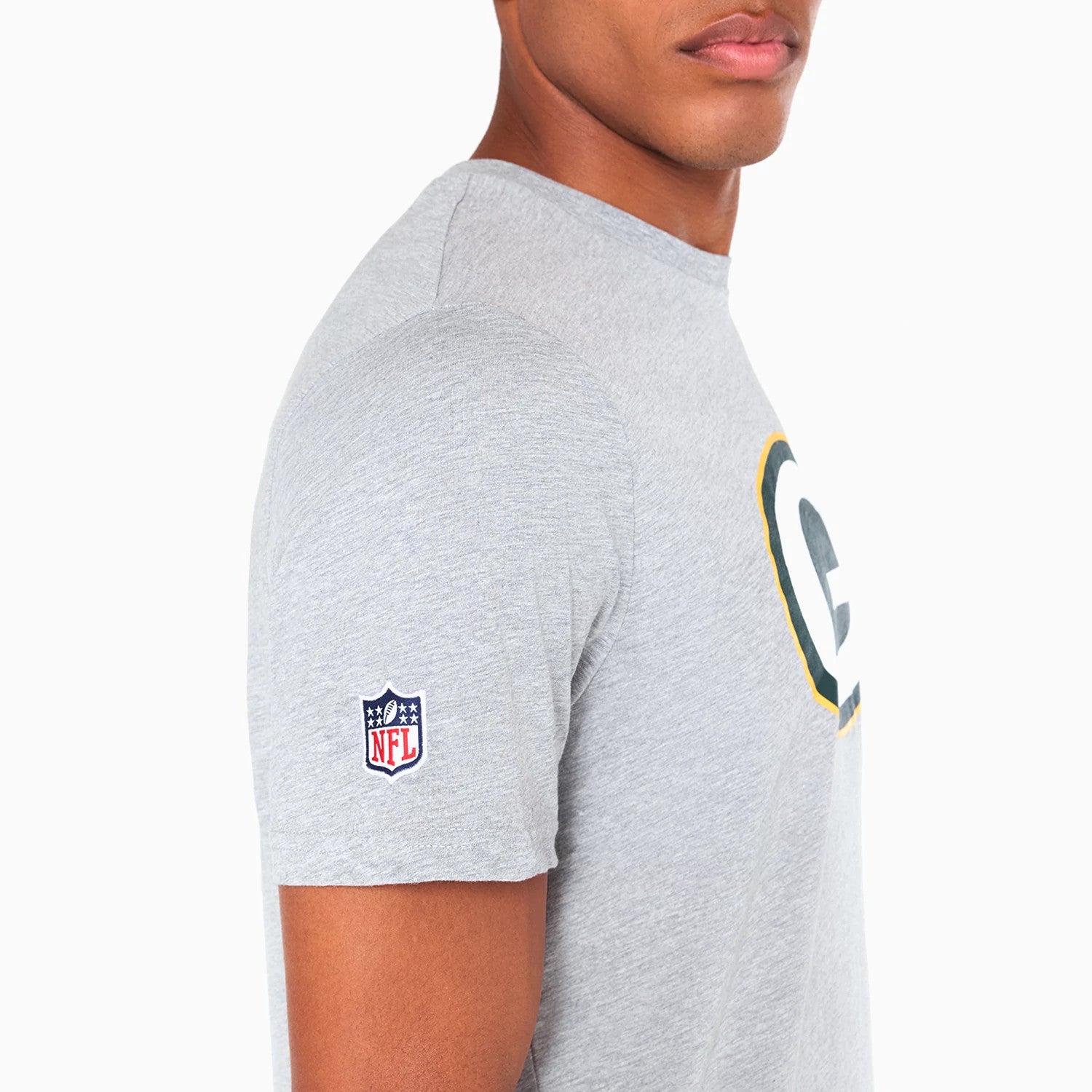 New Era Green Bay Packers NFL Grey T-Shirt, side view showing the grey fabric with a small embroidered NFL logo on the sleeve and part of the large Green Bay Packers emblem printed across the chest.