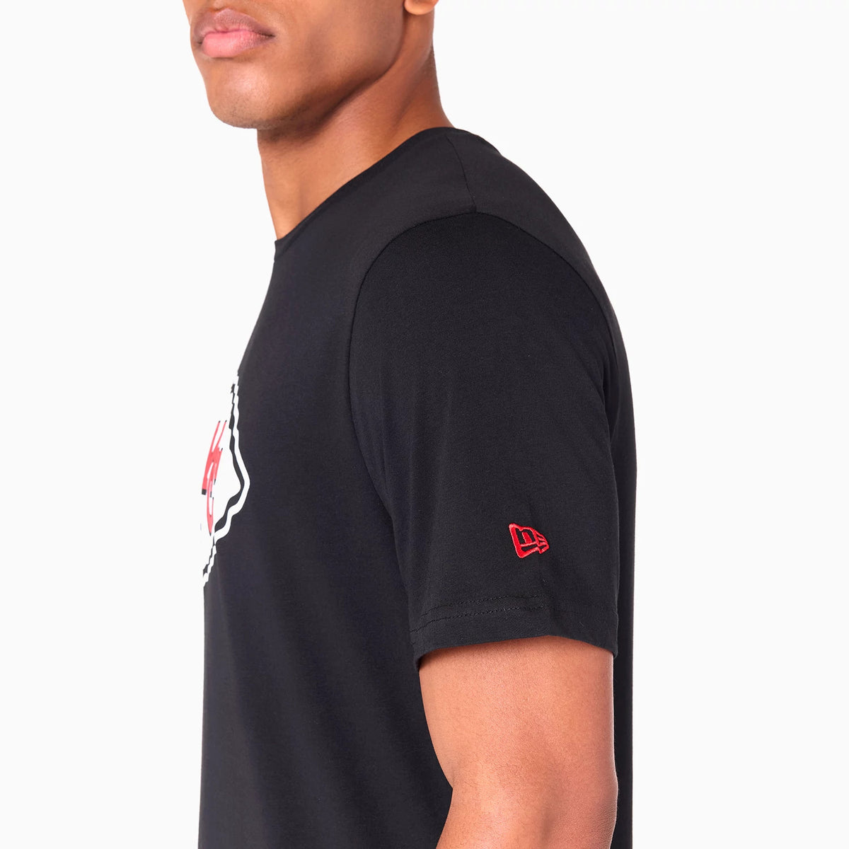 New Era Kansas City Chiefs NFL Black T-Shirt, side view featuring a red embroidered New Era logo on the sleeve and a portion of the large front graphic peeking from the side against the plain black fabric.