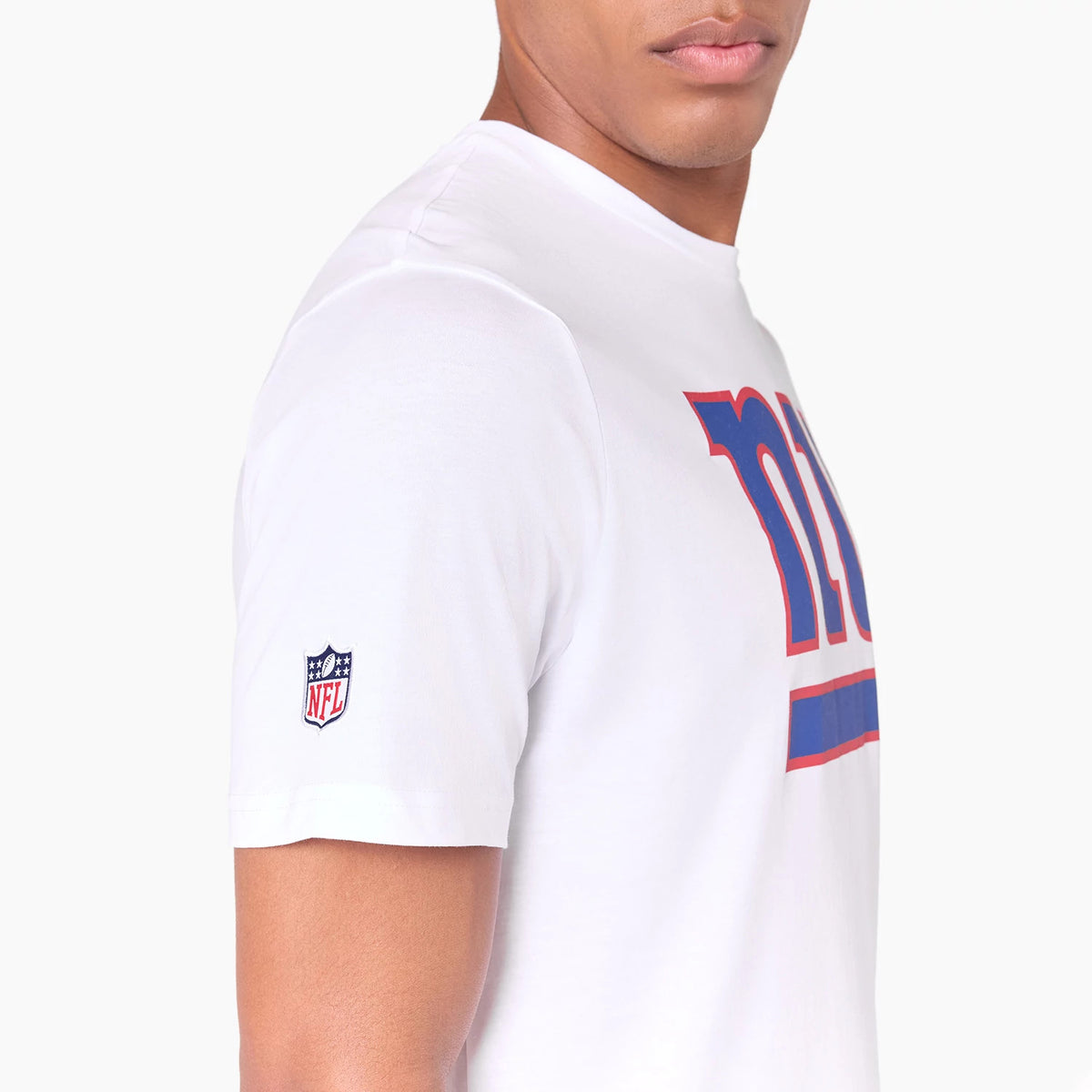 New Era New York Giants NFL White T-Shirt, side view showing the large blue and red ny graphic across the chest and a raised NFL logo on the left sleeve against a plain white background.