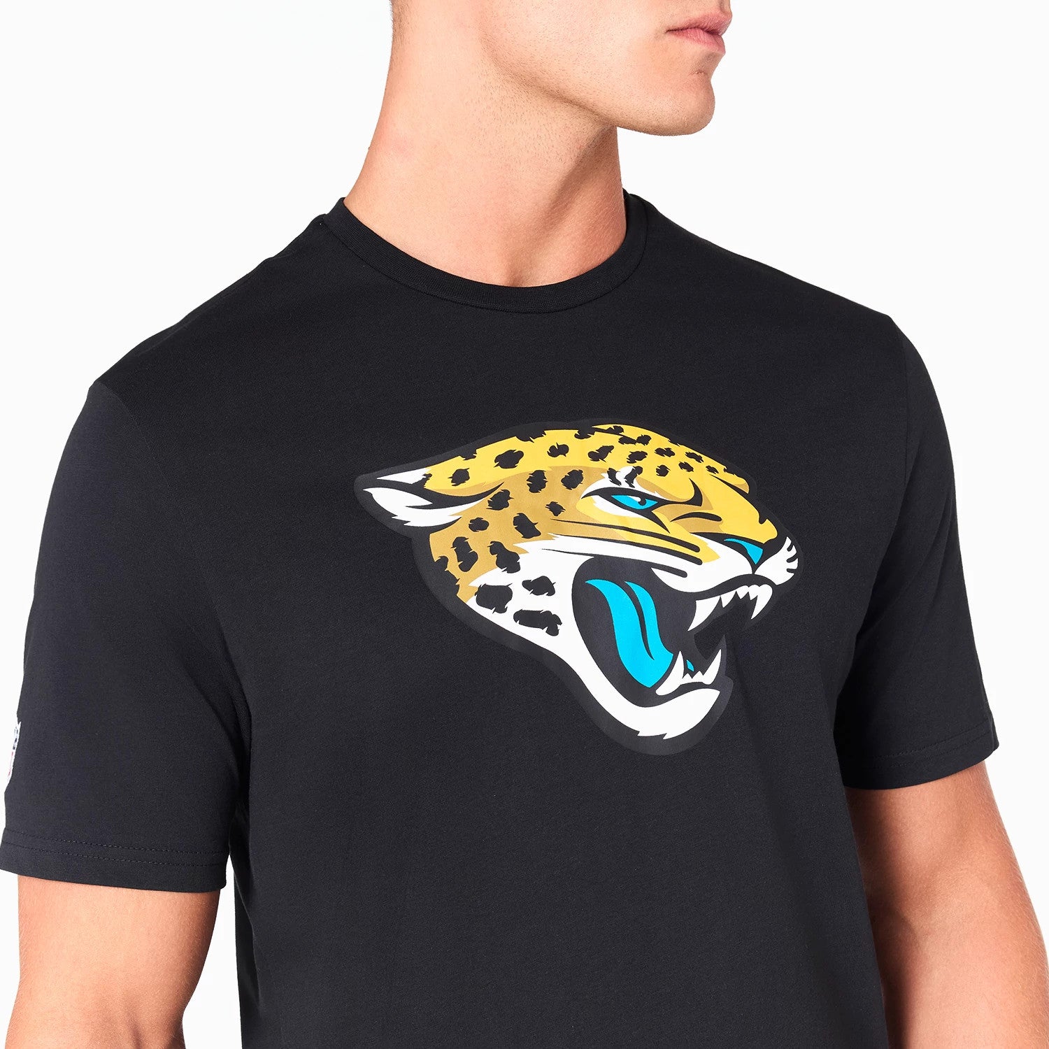 New Era Jacksonville Jaguars NFL Black T-Shirt, on-model view showing the large printed team logo of a jaguar head centred on the chest, with a simple round neckline and short sleeves.