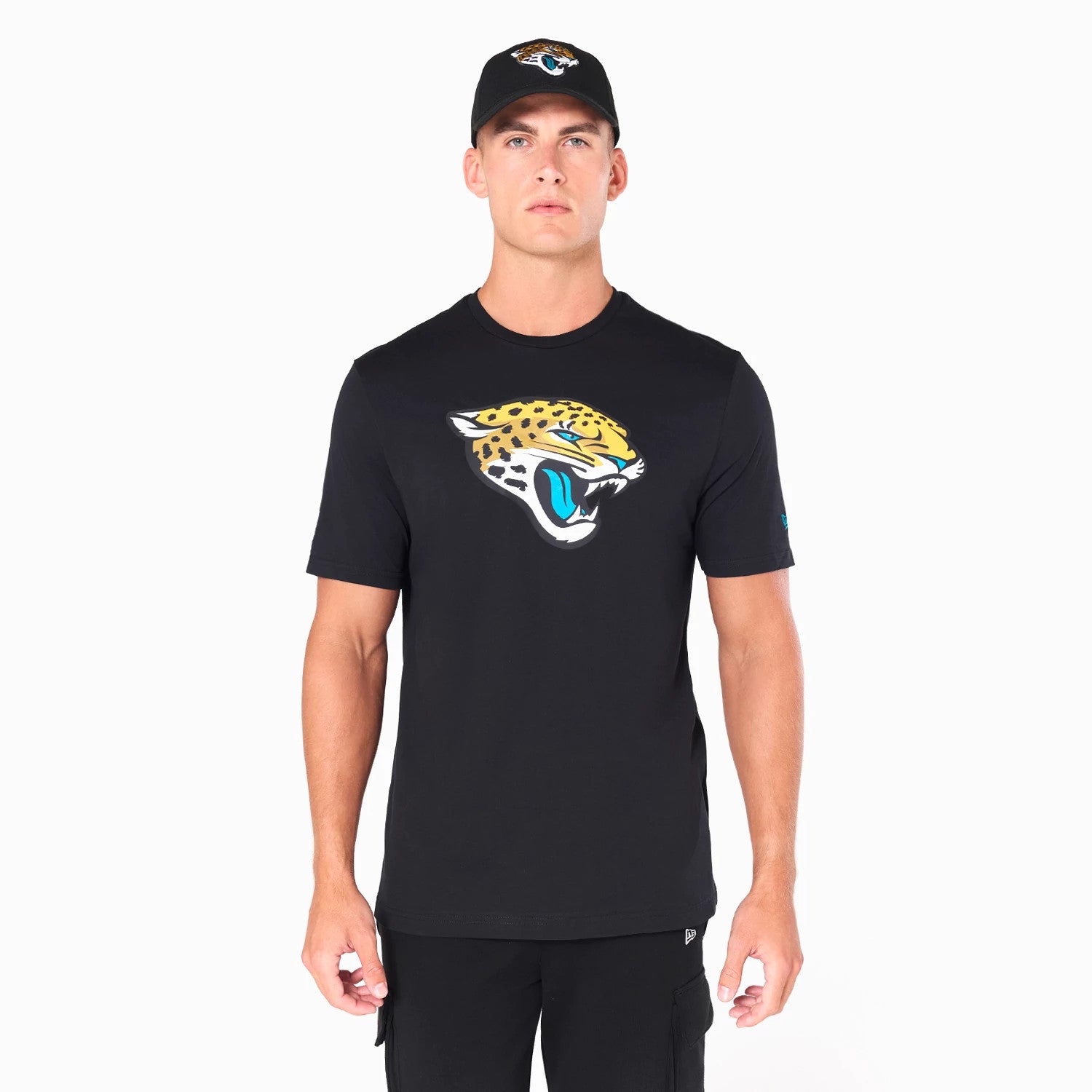 New Era Jacksonville Jaguars NFL Black T-Shirt, front view showing the large Jacksonville Jaguars logo printed on the chest, worn by a model also wearing a black cap with an embroidered Jaguars logo on the front.