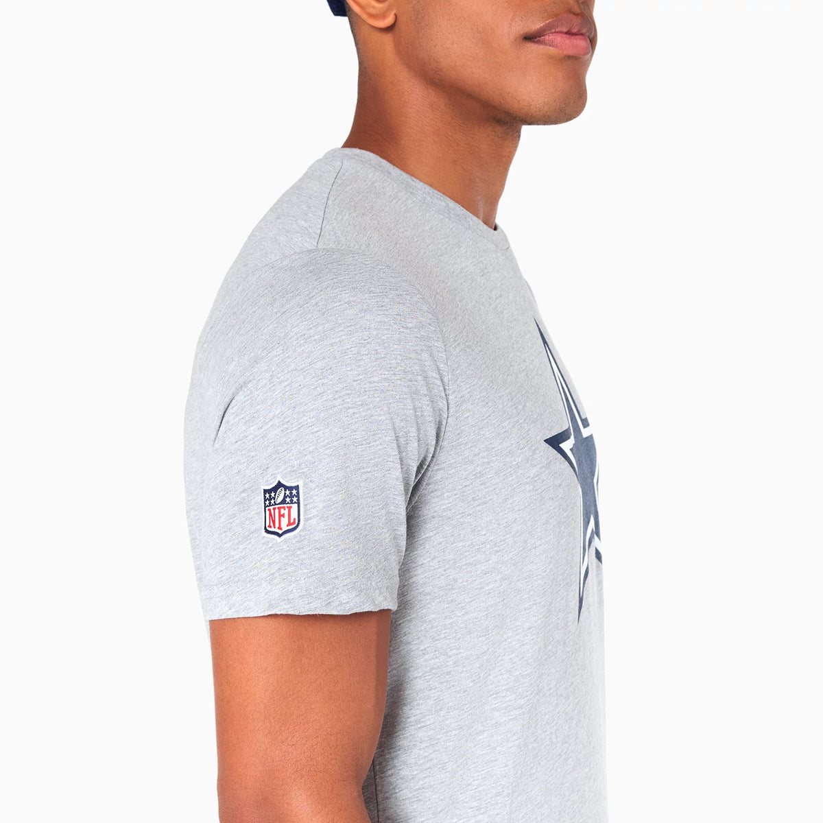 New Era Dallas Cowboys NFL Grey T-Shirt, side view showing a grey short-sleeve design with a raised Dallas Cowboys star logo on the front and an embroidered NFL patch on the left sleeve.