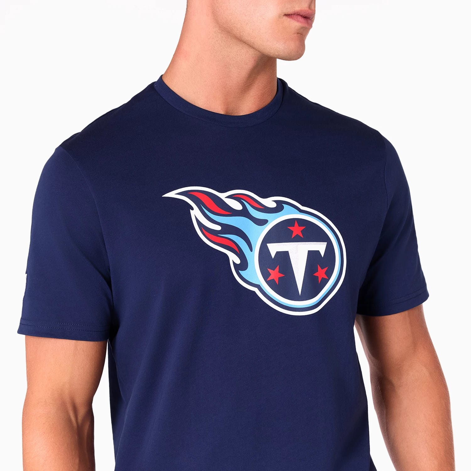New Era Tennessee Titans NFL Navy T-Shirt, three-quarter view showing the large printed team logo with red stars and blue flame design on the chest, short sleeves and a round neckline.
