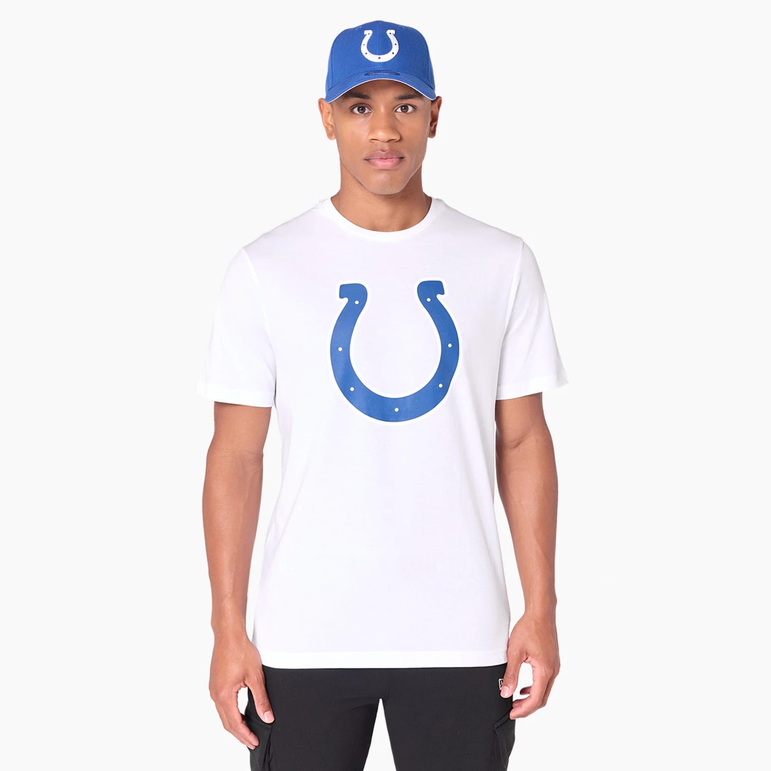 New Era Indianapolis Colts NFL White T-Shirt, on-model view showing a large blue horseshoe logo centred on the chest, worn with a blue cap featuring a raised white horseshoe logo on the front panel.