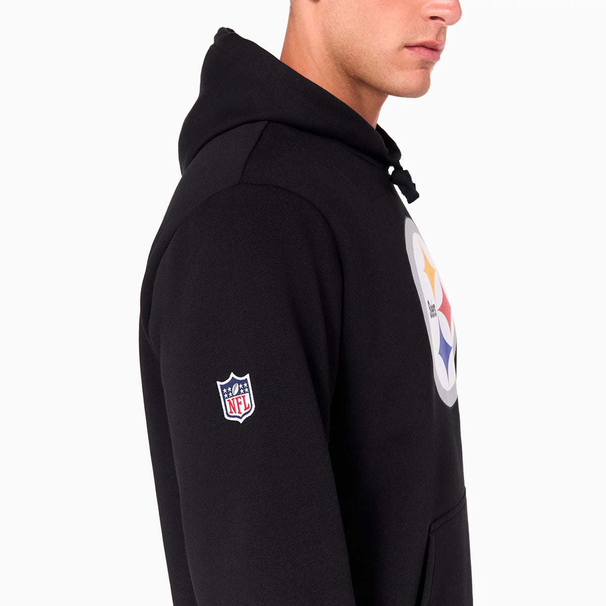 New Era Pittsburgh Steelers NFL Black Pullover Hoodie, side view showing the black fabric with a large printed Pittsburgh Steelers logo on the chest and an embroidered NFL logo patch on the upper sleeve.